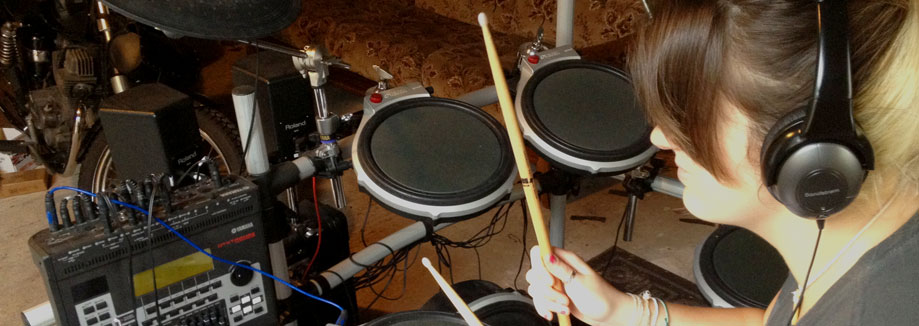 Emily playing an electronic drum kit
